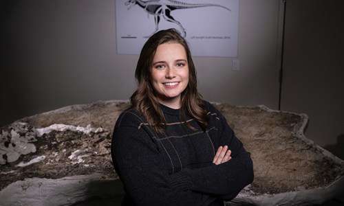 Alex poses in front of the "Teen Rex" specimen