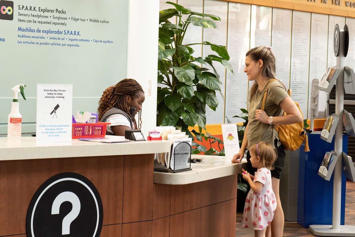 A mom and a daughter at the information desk