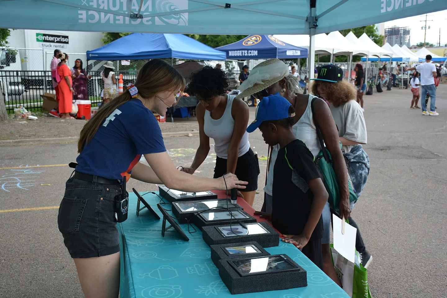 Museum staff hosting discovery station activity at community event