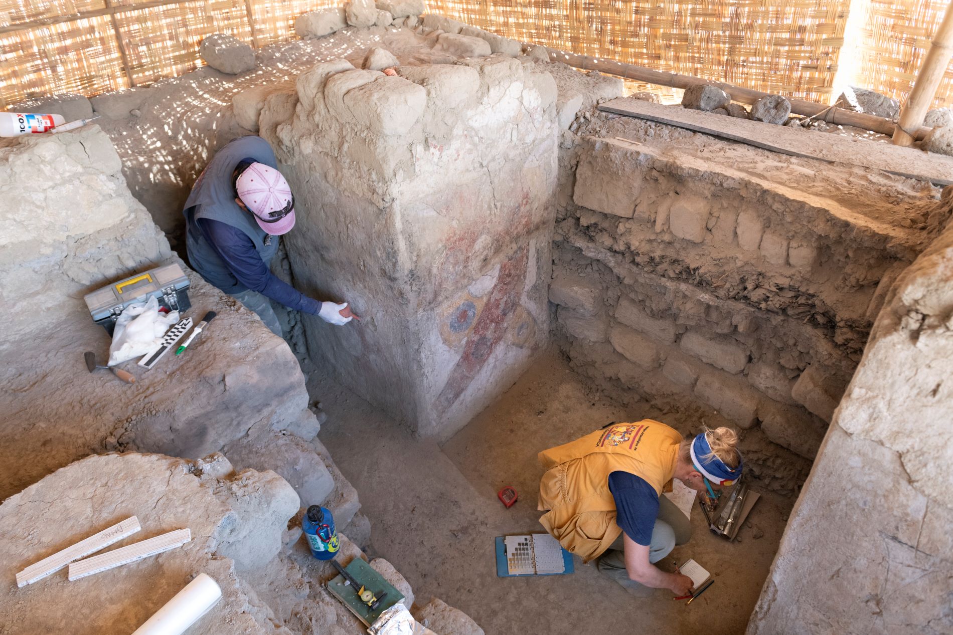 Conservator Alex Clavo Cruz and Denver Museum of Nature & Science Archaeologist Michele Koons working to conserve and document paintings in the "Hall of the Braided Serpents" in Pañamarca, Peru. (Photo/ Rick Wicker)