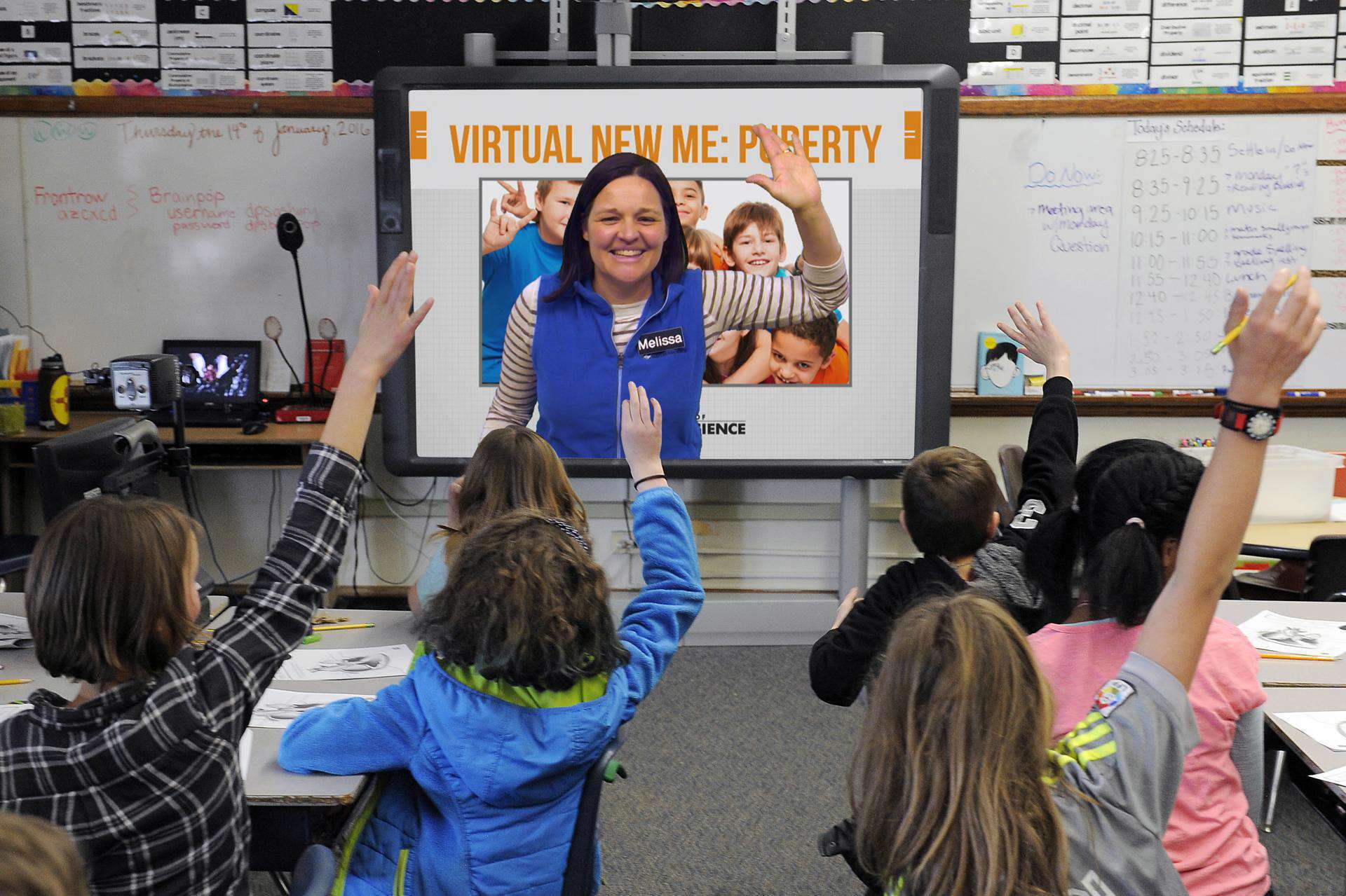 Students raise their hands and engage during a virtual class.